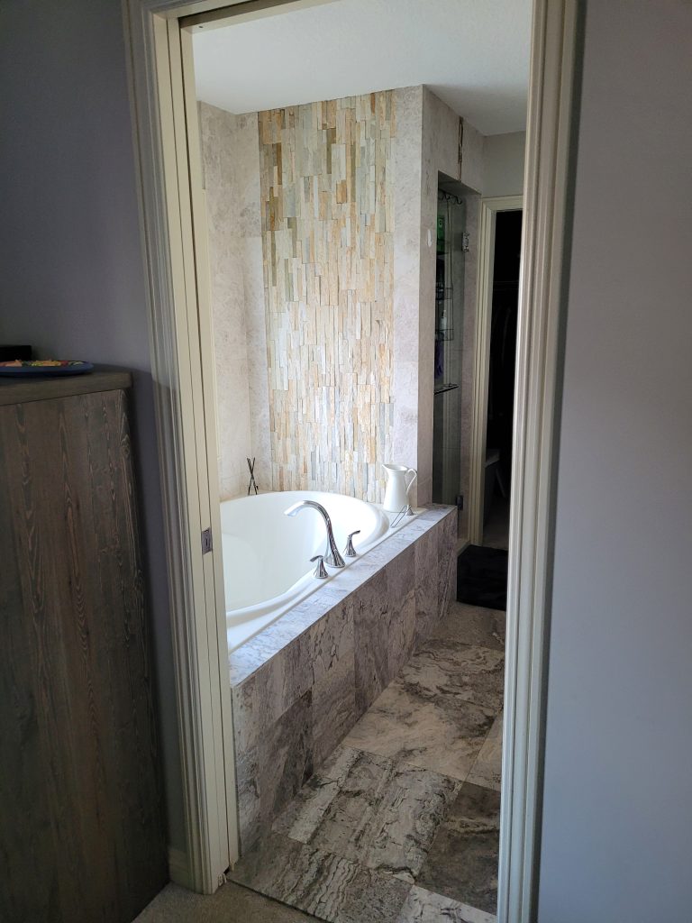 Before: built-in bathtub with stone tile surround