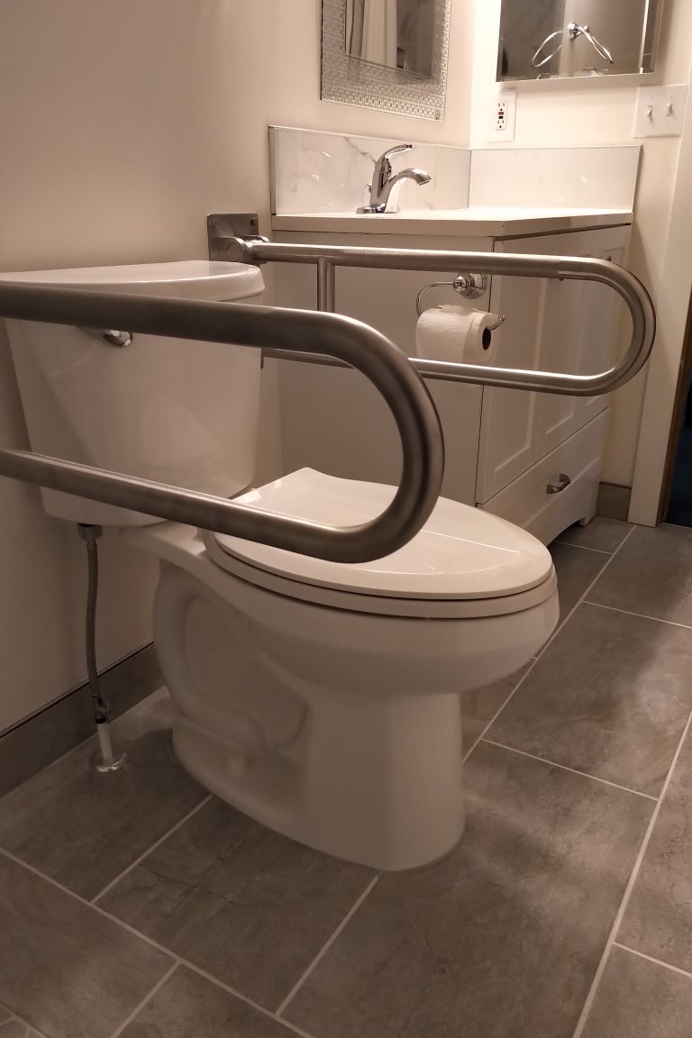 Toilet with folding grab bars