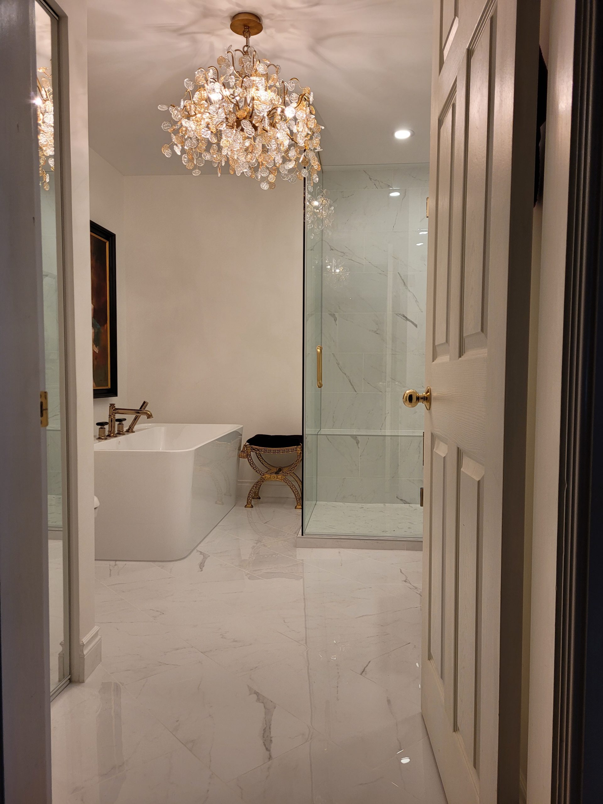 Ensuite with chandelier and freestanding tub