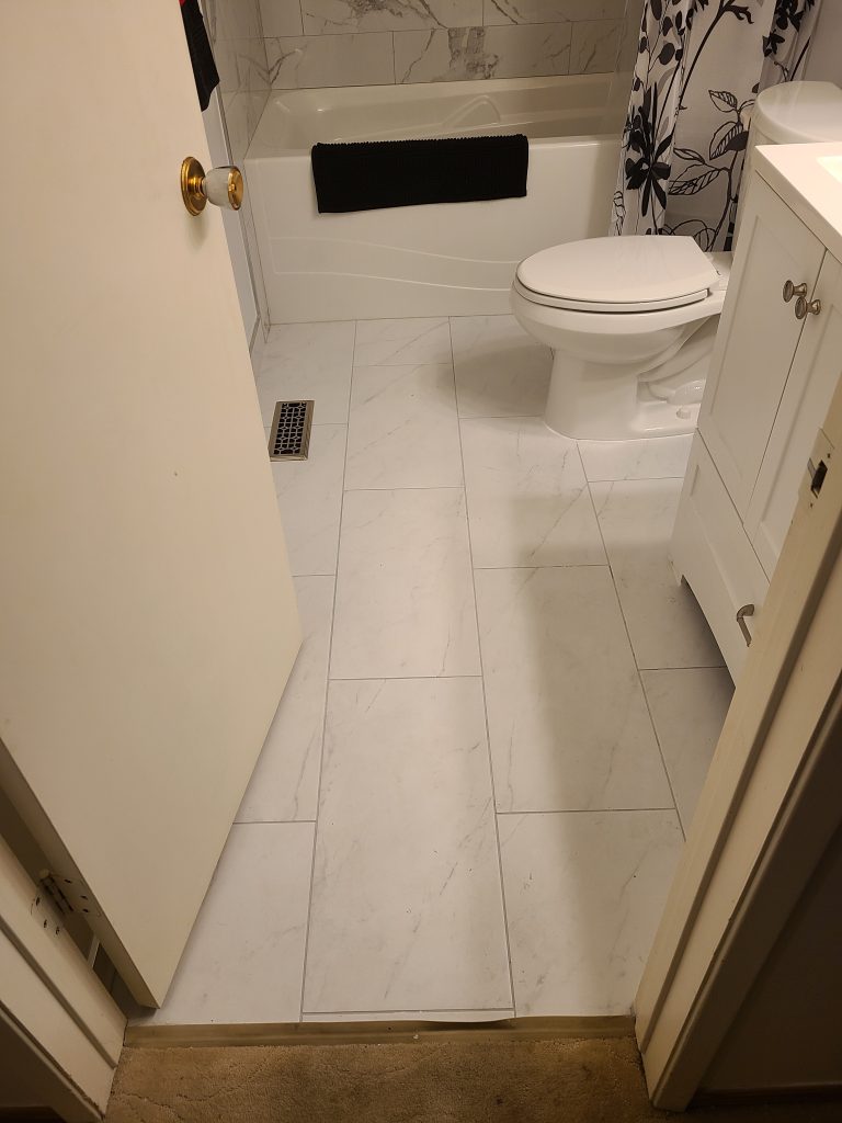 Tub-shower bathroom with light tile